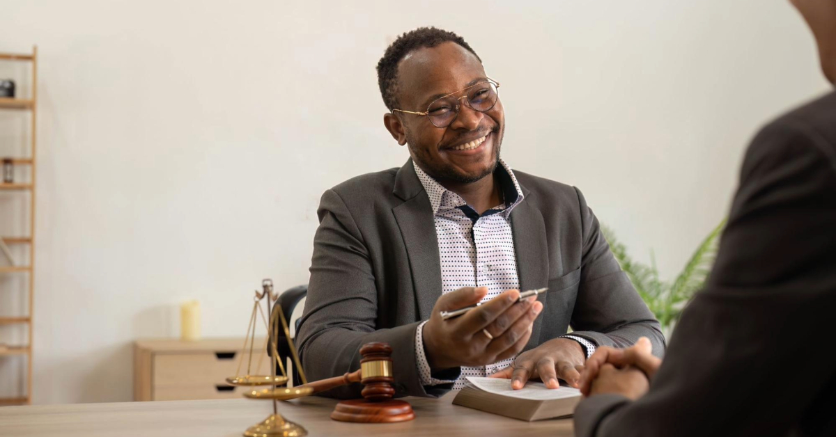 a man discussing a contract with a lawyer