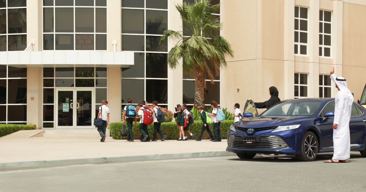An Arab couple drops their children off at school
