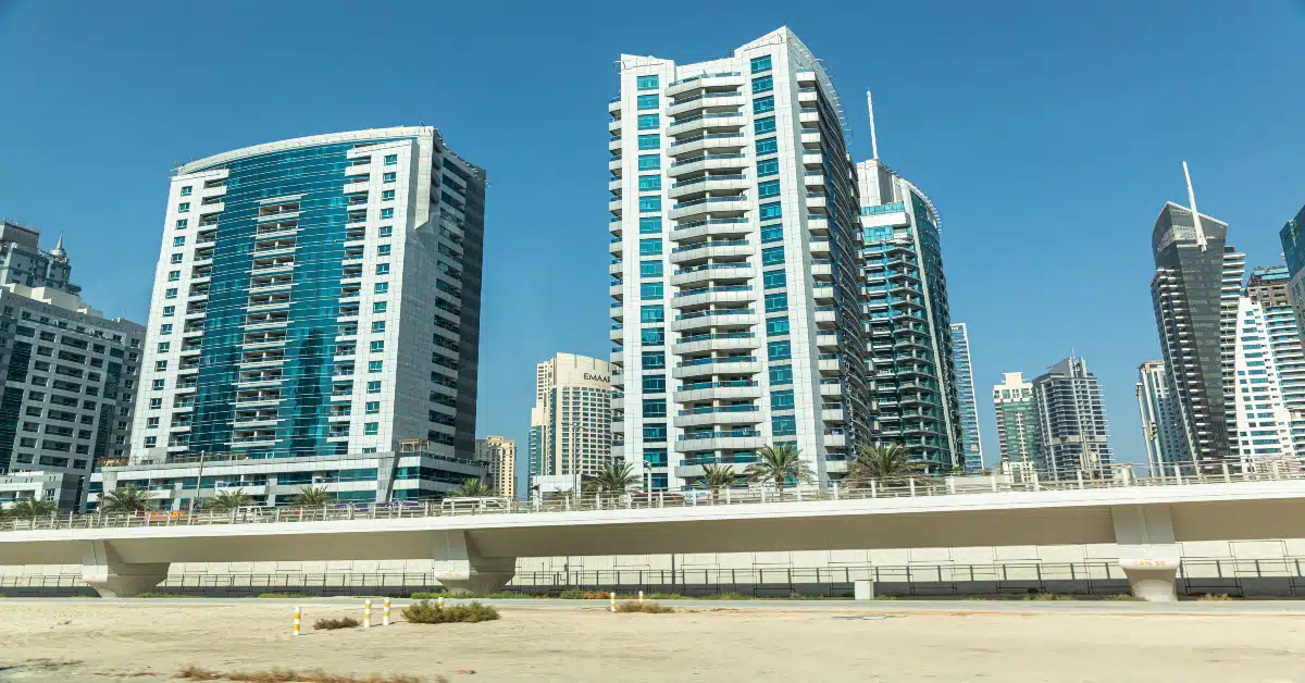 Dubai skyscrapers with balconies and landscaped surroundings.