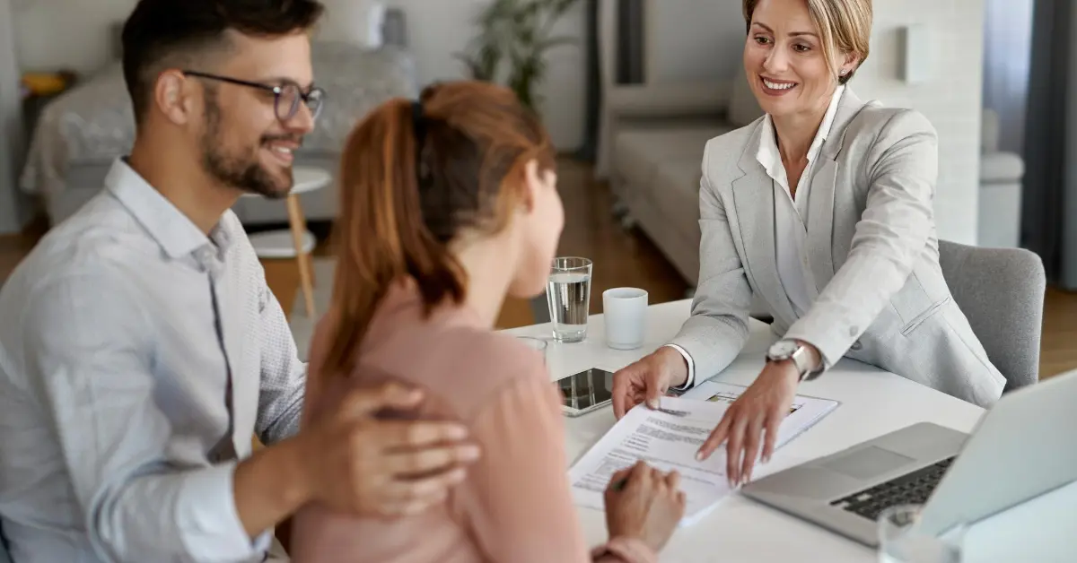 real estate agent preparing the house contract with a couple