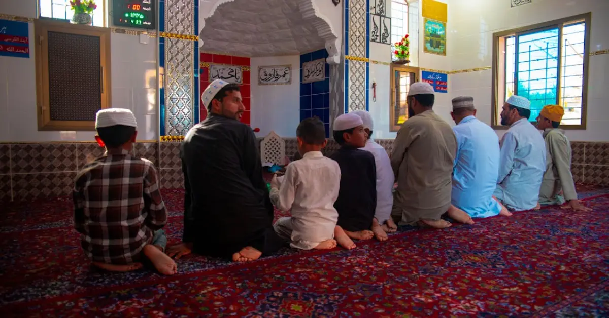 men and boys praying at a mosque