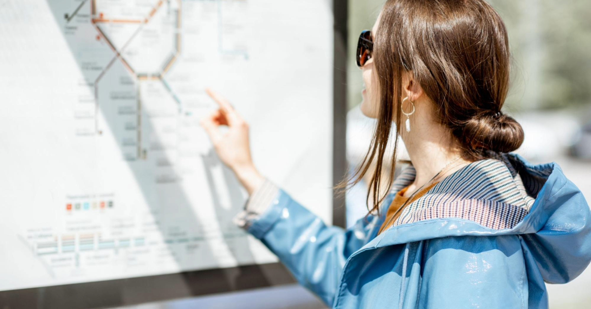 Woman checking the metro map at the station