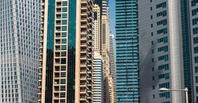 modern high-rise skyscrapers with glass facades and balconies in a dense urban skyline