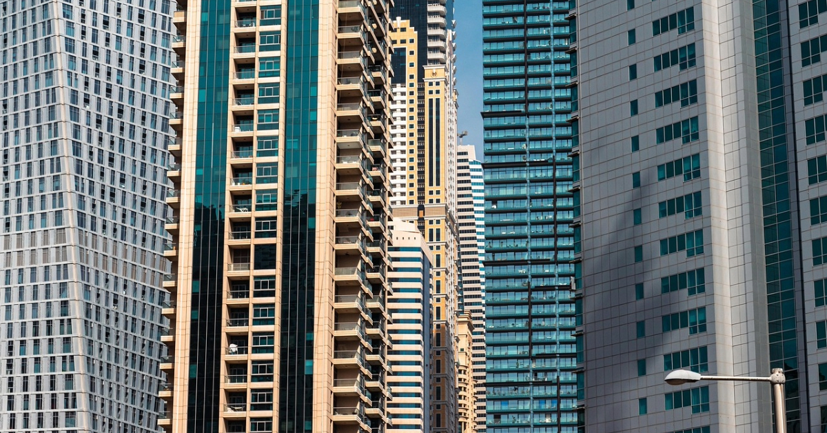 modern high-rise skyscrapers with glass facades and balconies in a dense urban skyline