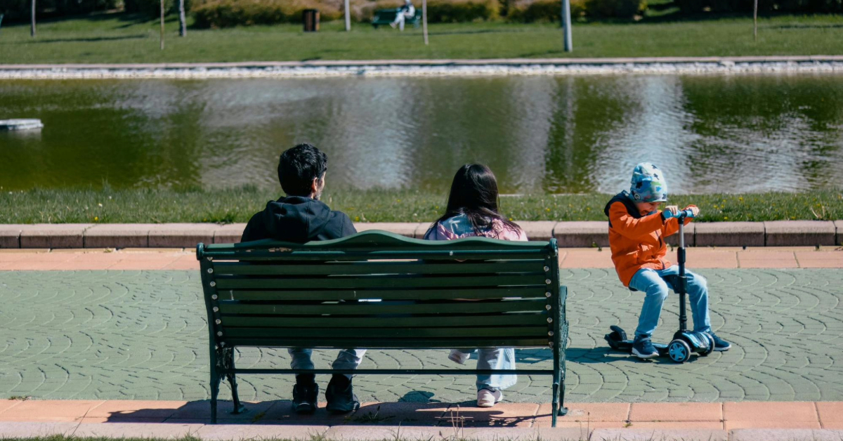 Family hanging around on a park bench