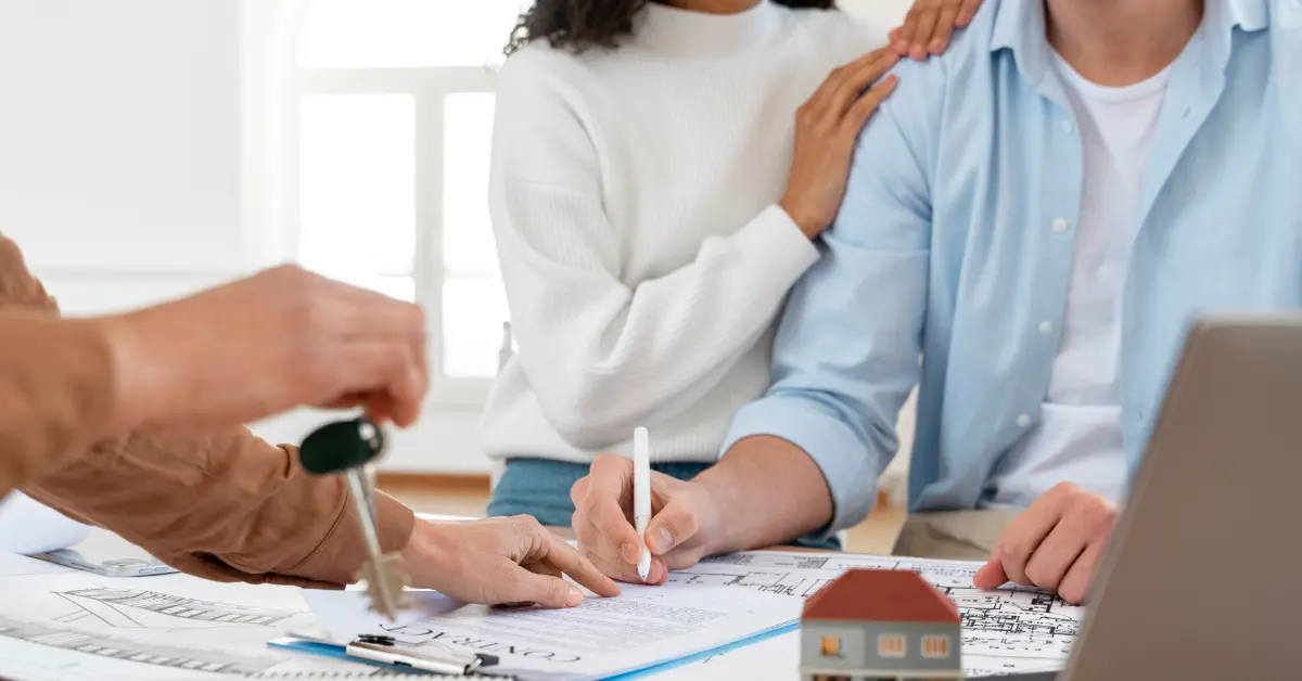 Smiley couple signing contract for new house