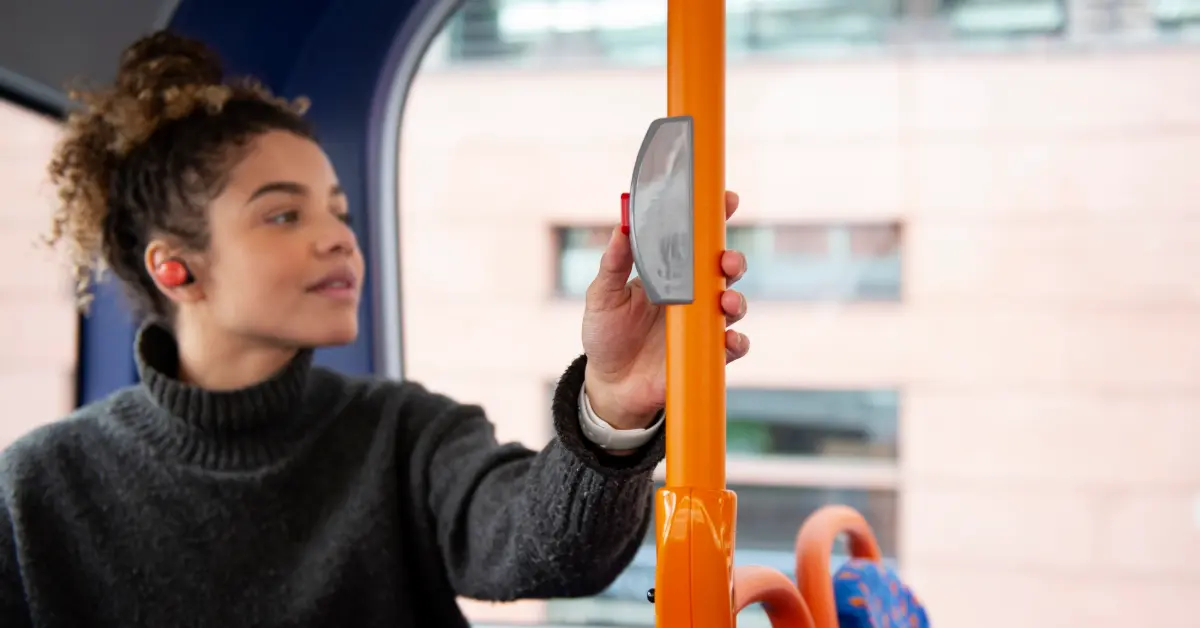 Young woman stopping the bus in the city