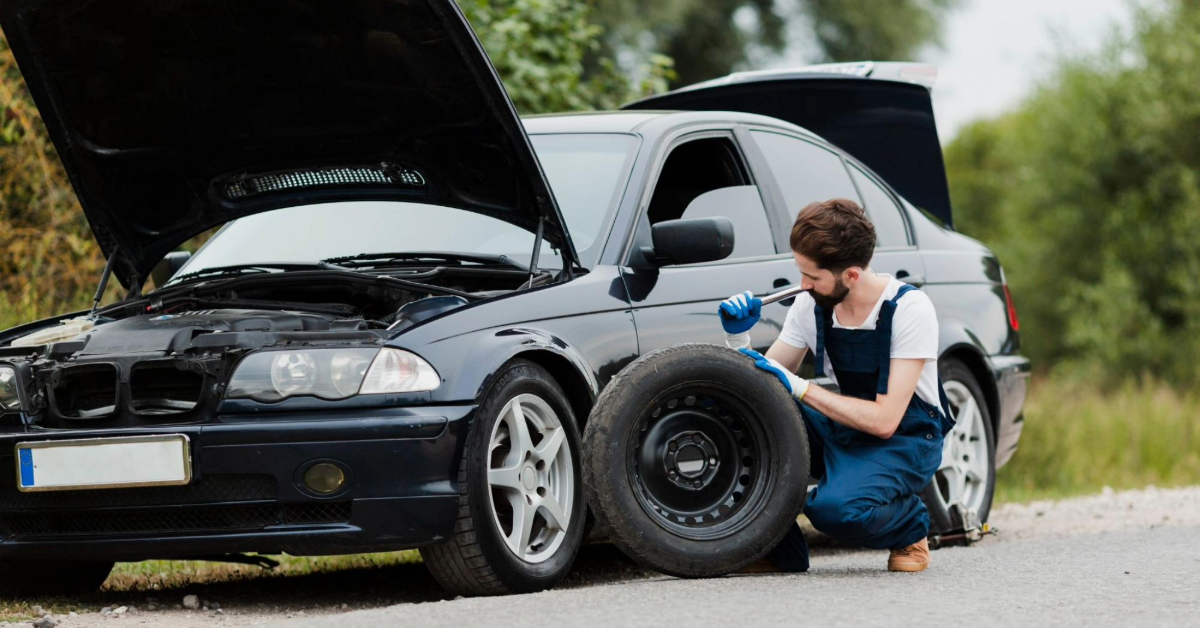 A mechanic assisting with a tyre change