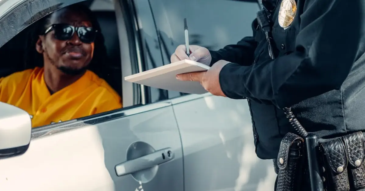 A policeman writing a traffic fine to the driver