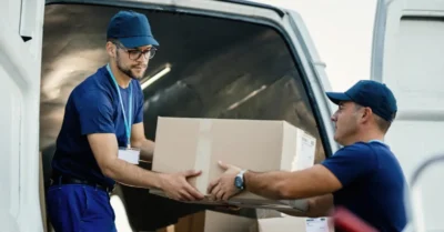 Movers carefully unloading boxes