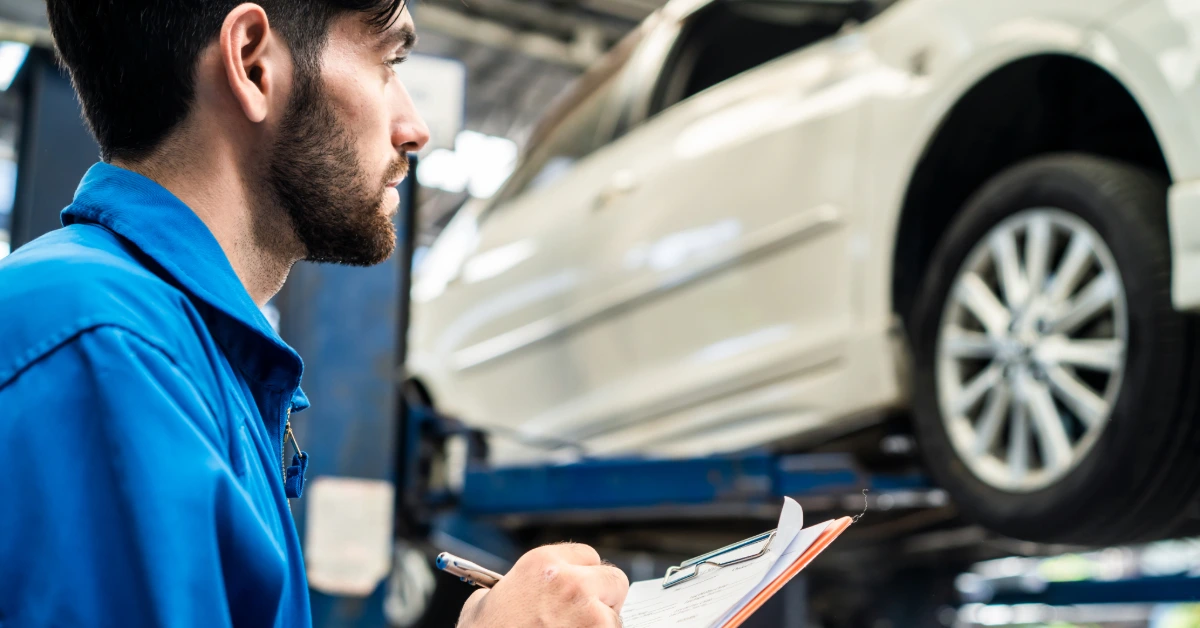 a man inspecting the car at an inspection centre