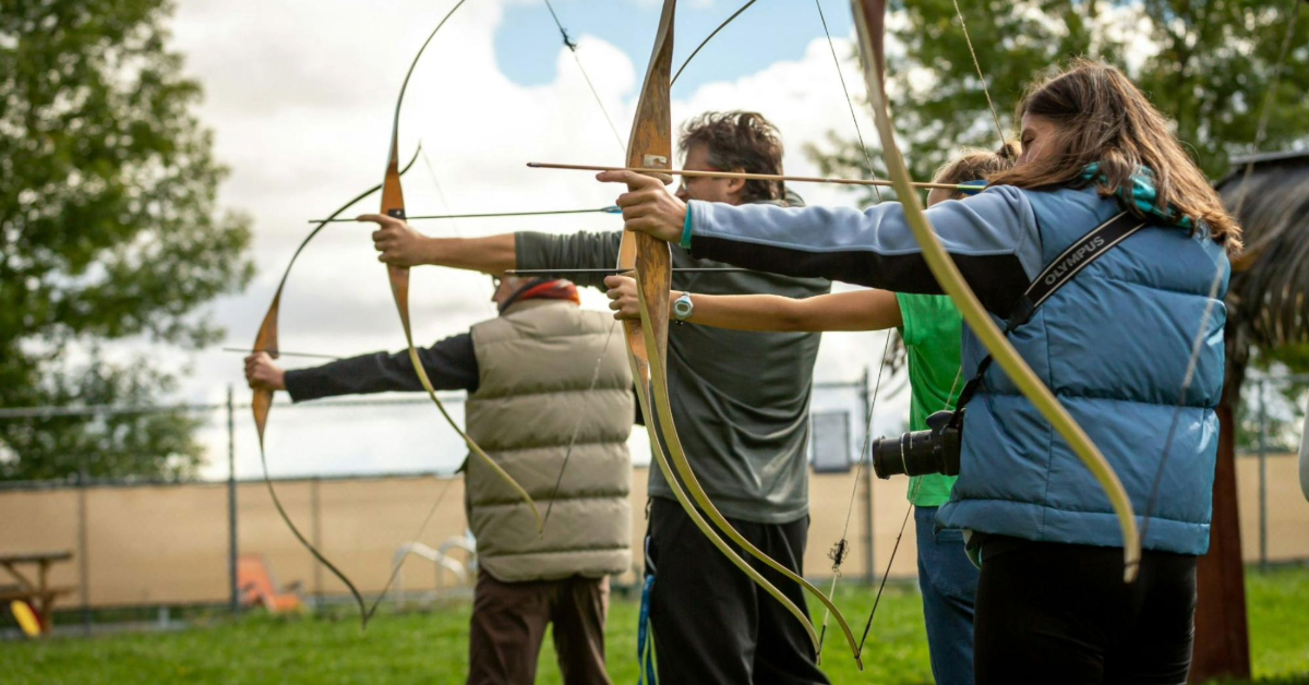 Three adults aiming to make a shot
