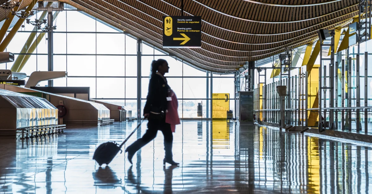 Woman walking at Abu Dhabi Airport with luggage