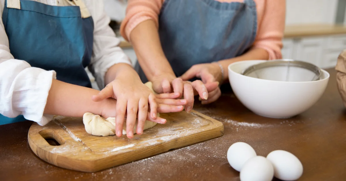 A chef teaching the kneading process in a baking class