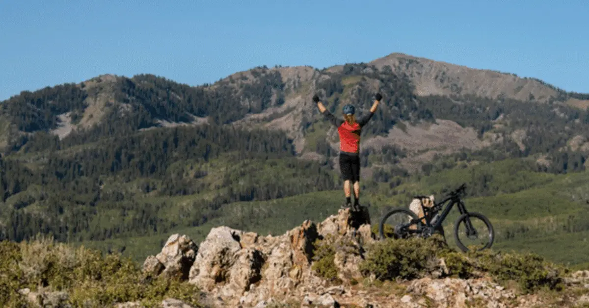 A biker celebrating by reaching the end of the biking trail