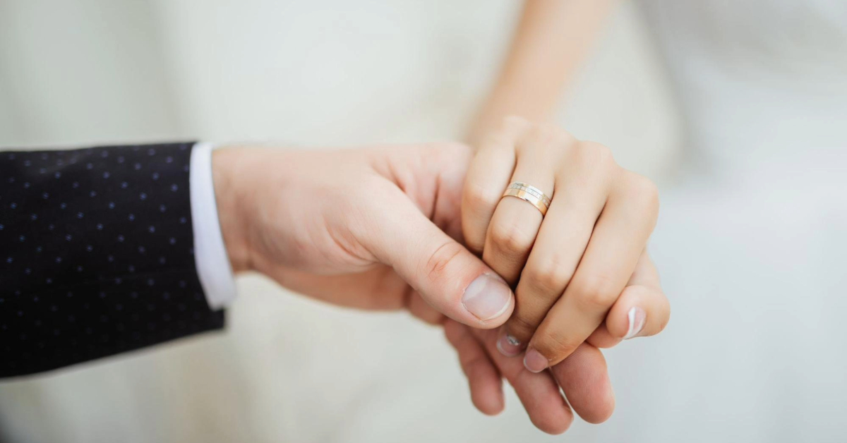A close-up shot of a married couple’s hands, symbolizing their union.