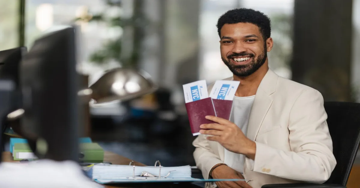 A man holding his passport and tickets to Greece