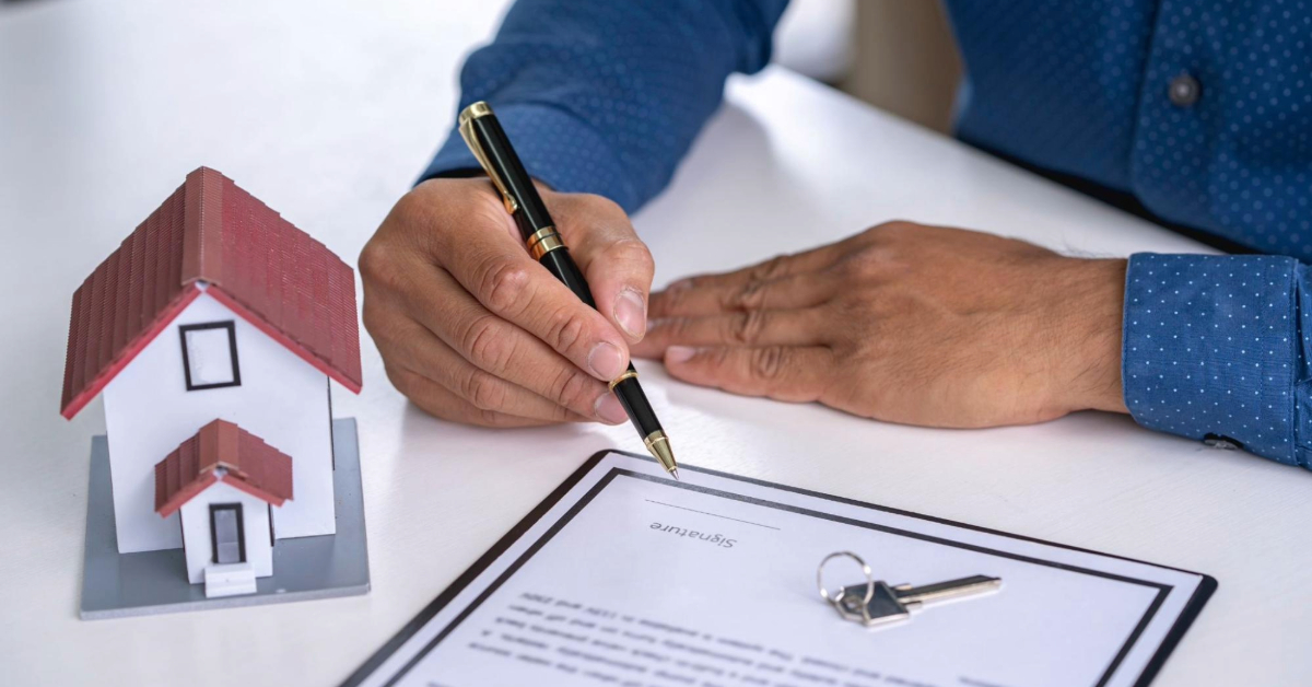 Man signing a contract after buying a home