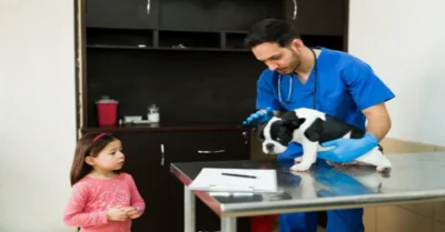 A vet in Dubai, taking care of a dog in front of a child