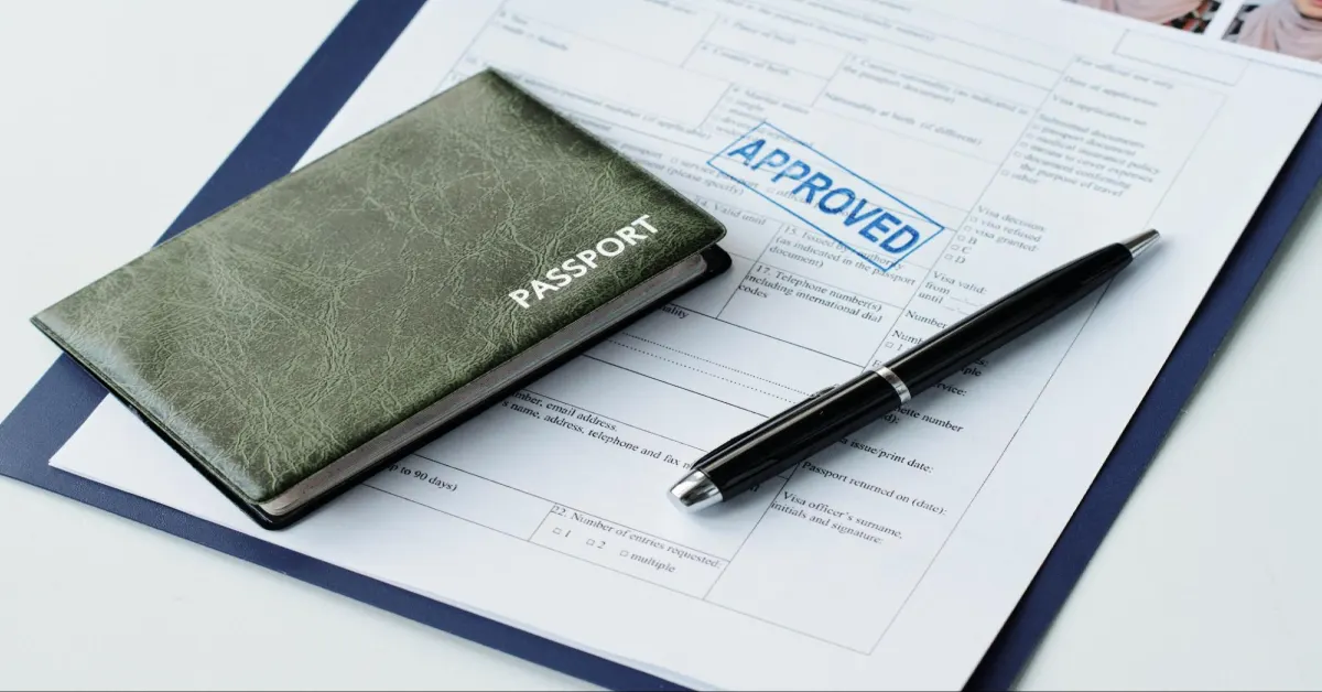 passport in leather cover, travel visa application paper with approved stamp 