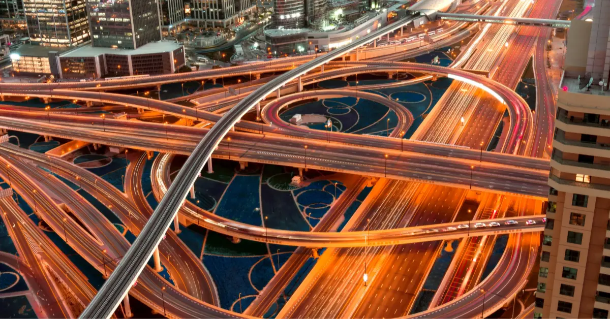 High angle shot of an illuminated highway with multilevel intersections in a megapolis at night