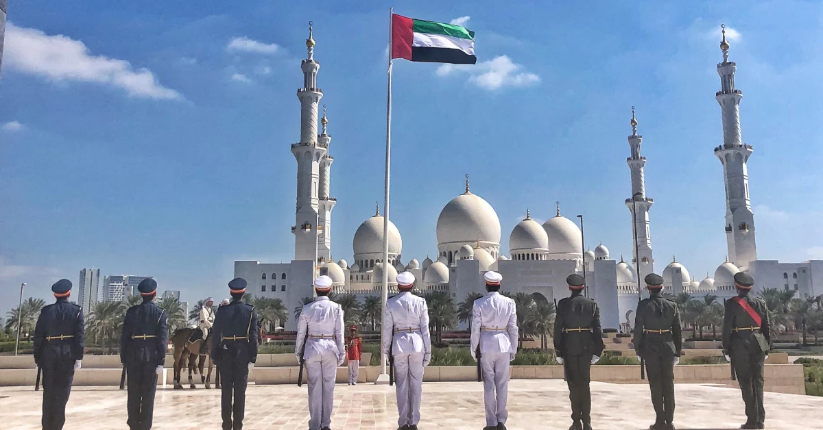 police officers saluting the UAE flag in Sharjah