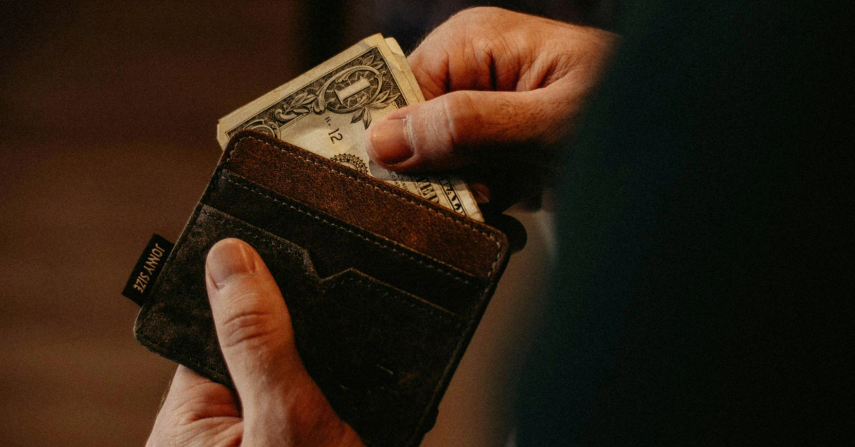 A man taking out cash from his wallet