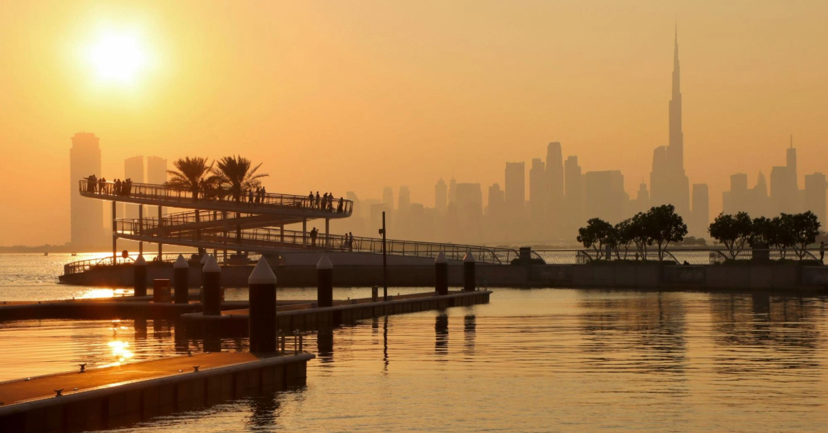 A sunset view of the Dubai Creek with Burj Khalifa in the background