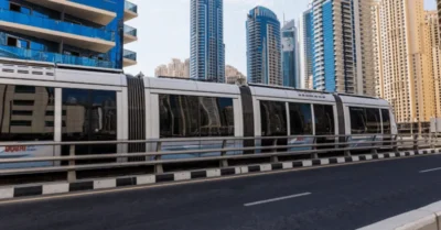 Dubai metro passing by commercial buildings