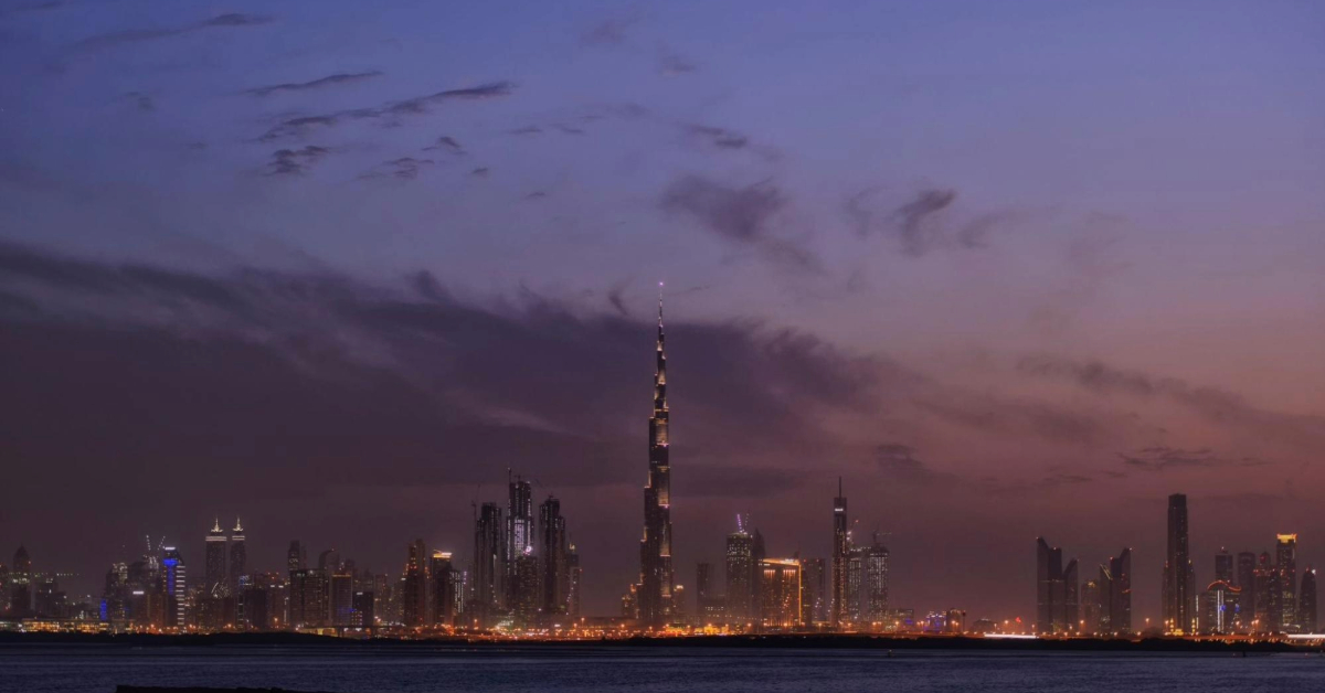 A sunset view of the Dubai skyline across the water