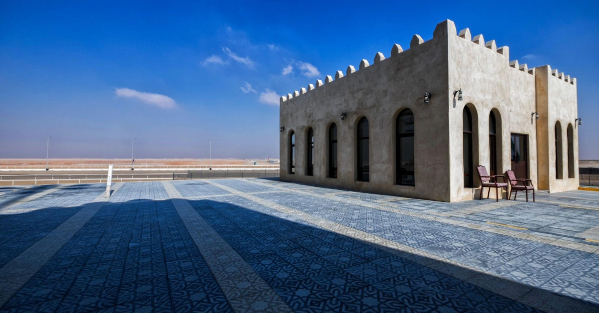 Traditional Emirati Stone Building With Arched Windows Overlooking a Desert Landscape in Al Dhafra, Abu Dhabi