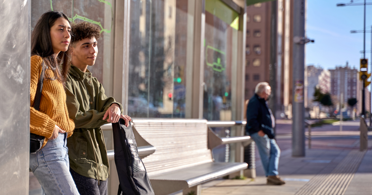 Friends waiting for the bus at the stop