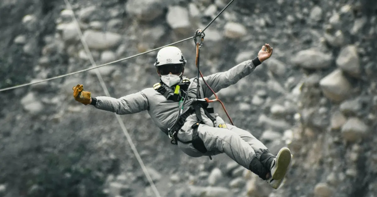 Man on zipline on mountains