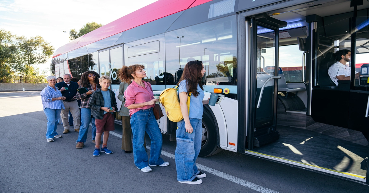 Passengers queuing to get on a bus