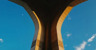 Stone Arches of a Mosque Framed Against a Clear Blue Sky