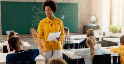 Teacher cheering a student for passing a test