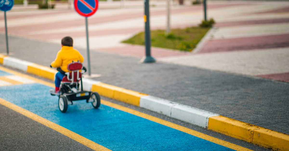 Toddler is learning traffic rules while cycling in the lane