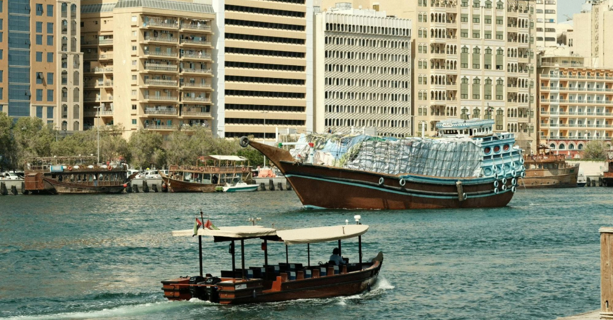 A Traditional Wooden Abra Boat and a View of the Deira City Skyline