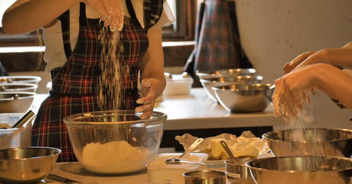 Students preparing cake bases in a baking class in Sharjah