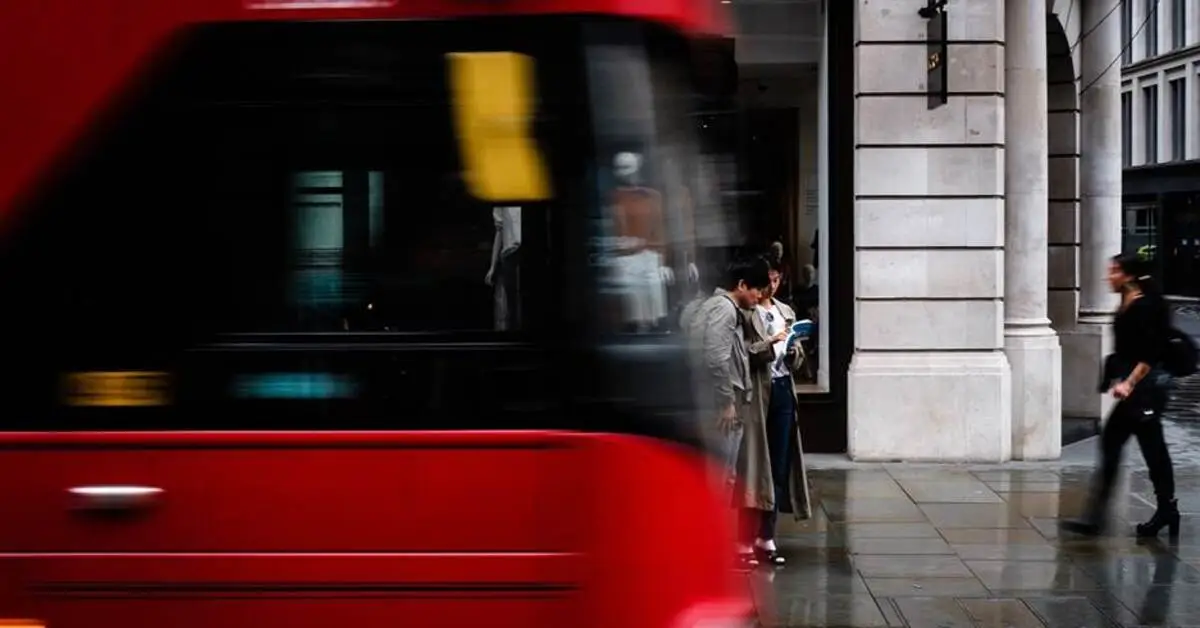 Street-level view of bus and pedestrians near Business Bay