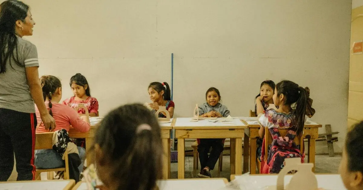 A group of children sitting inside a classroom