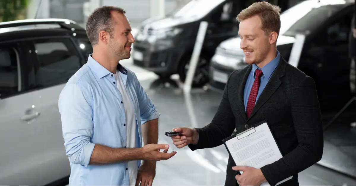 Close up on customer with business person in car dealership