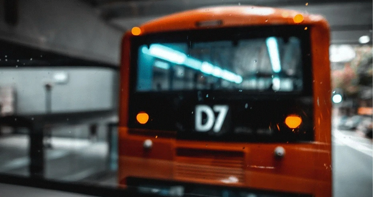 View of another bus from the backside of a bus