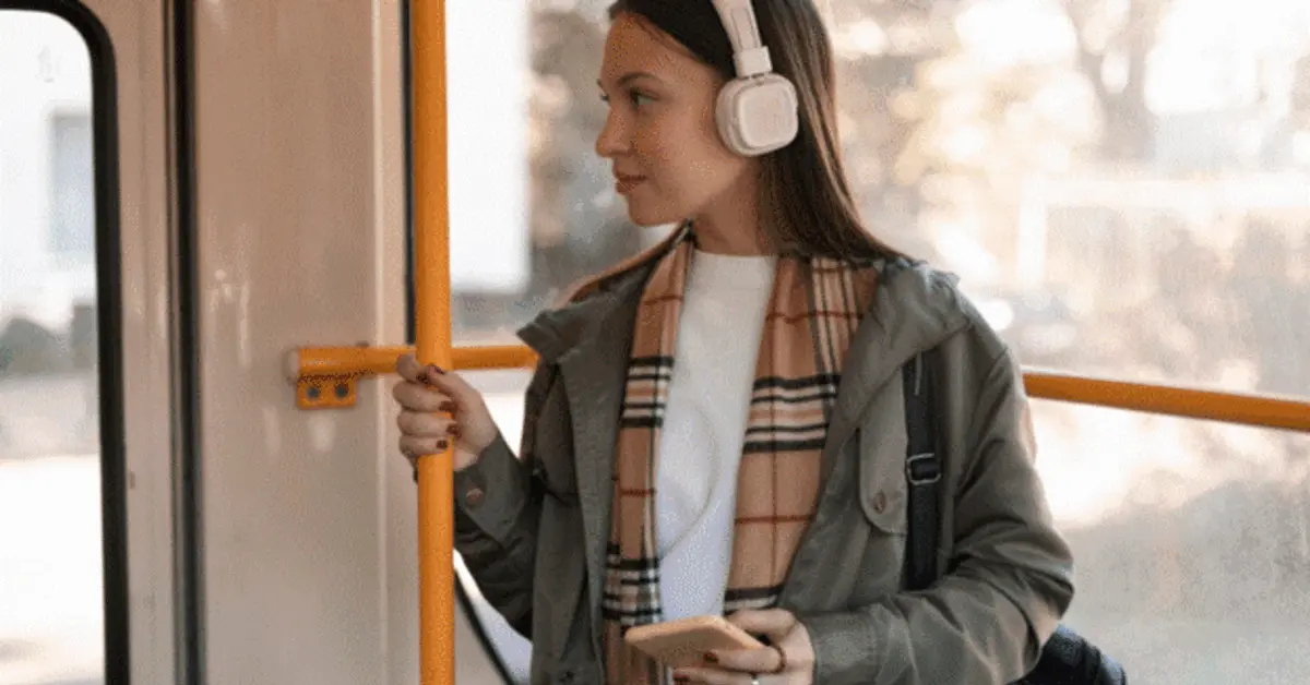 A woman standing inside the X13 bus in Dubai