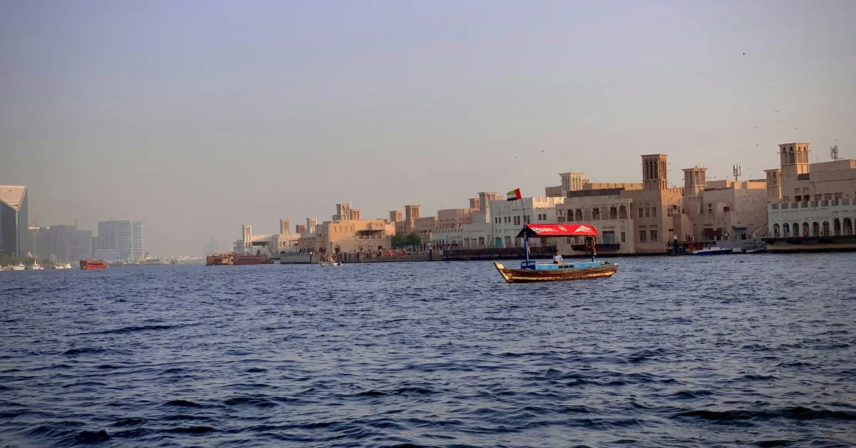 An Abra boat in the water with Al Seef in the background.