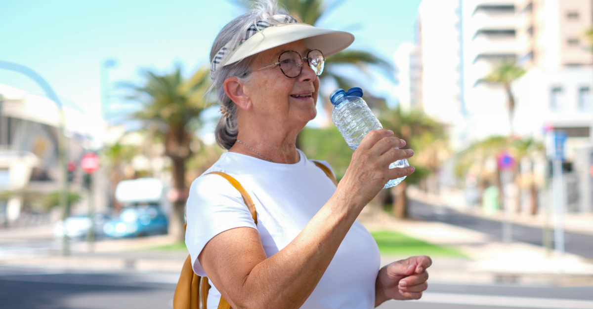 woman carrying a bottle of water along the urban street