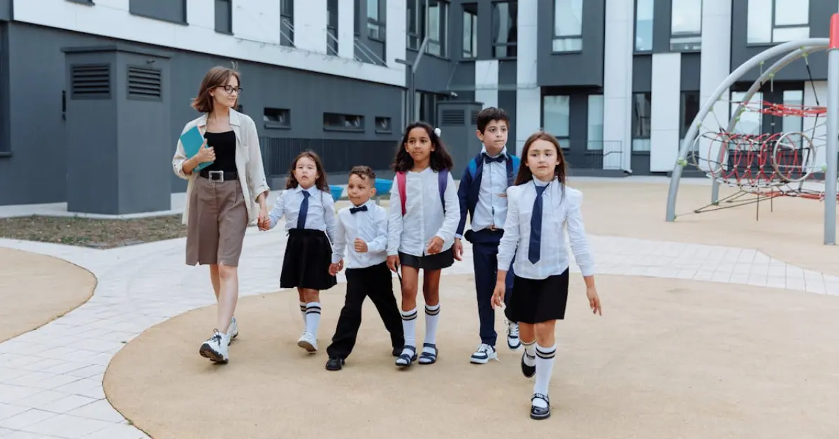 teacher with school kids walking in a school hallway