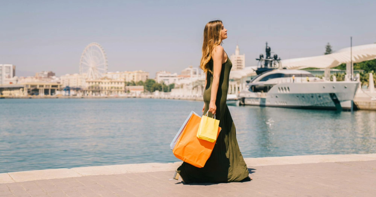 A woman carrying shopping bags by the sea side