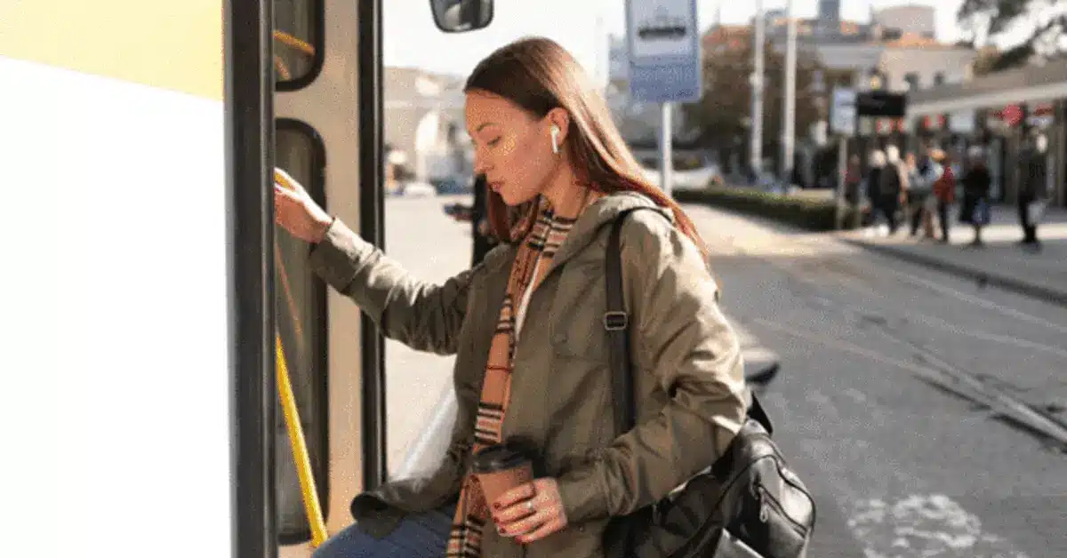 A woman getting on the X25 bus in Dubai