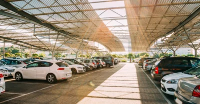 Cars on a covered parking lot in sunny summer day